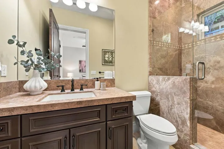 En-suite bath with granite vanity and glass shower, Los Gatos