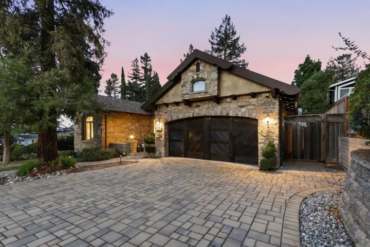 Stone garage and paver motor court at dusk, Los Gatos
