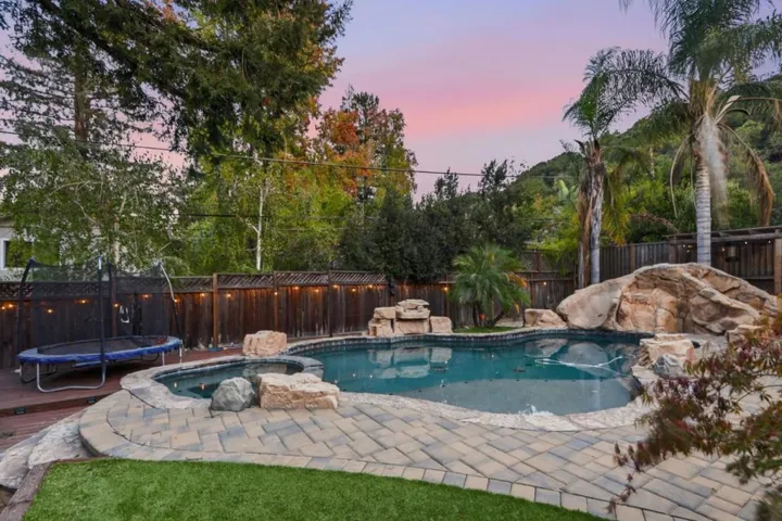 Pool and spa with rock features at twilight, Los Gatos