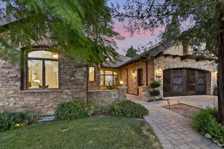 Stone and stucco front elevation glowing at twilight, Los Gatos