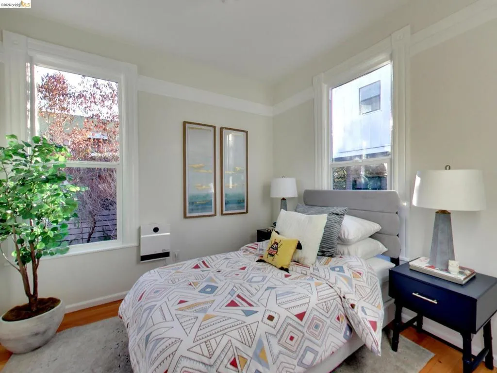 Neutral-toned interior featuring hardwood flooring, wide window casing, and crown molding Neutral-toned interior featuring hardwood flooring, wide window casing, and crown molding