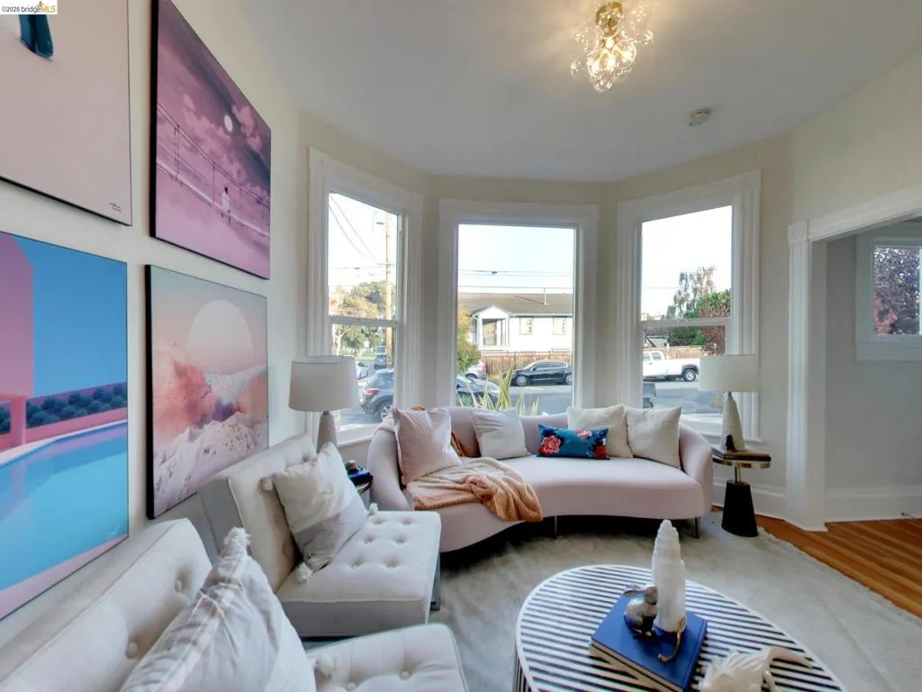 Bay window featuring three large windows, multi-pane window casing, crown molding, and ceiling-mounted light fixture Bay window featuring three large windows, multi-pane window casing, crown molding, and ceiling-mounted light fixture