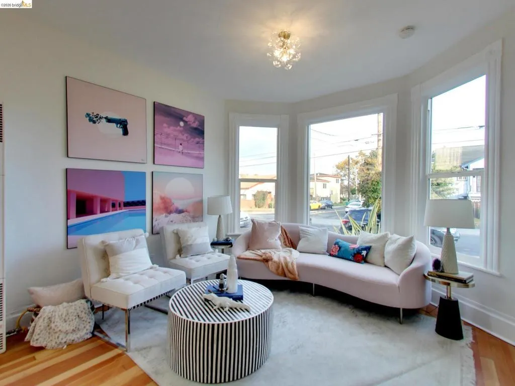 Bay window with three double-hung windows, wood-finish flooring, and multi-faceted glass semi-flush mount lighting Bay window with three double-hung windows, wood-finish flooring, and multi-faceted glass semi-flush mount lighting