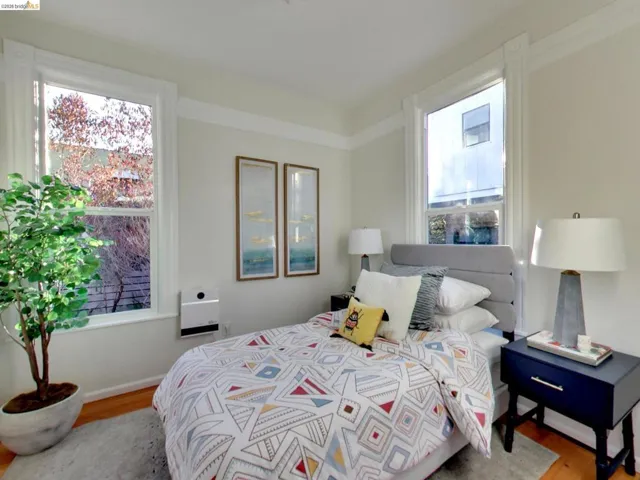 Neutral-toned interior featuring hardwood flooring, wide window casing, and crown molding