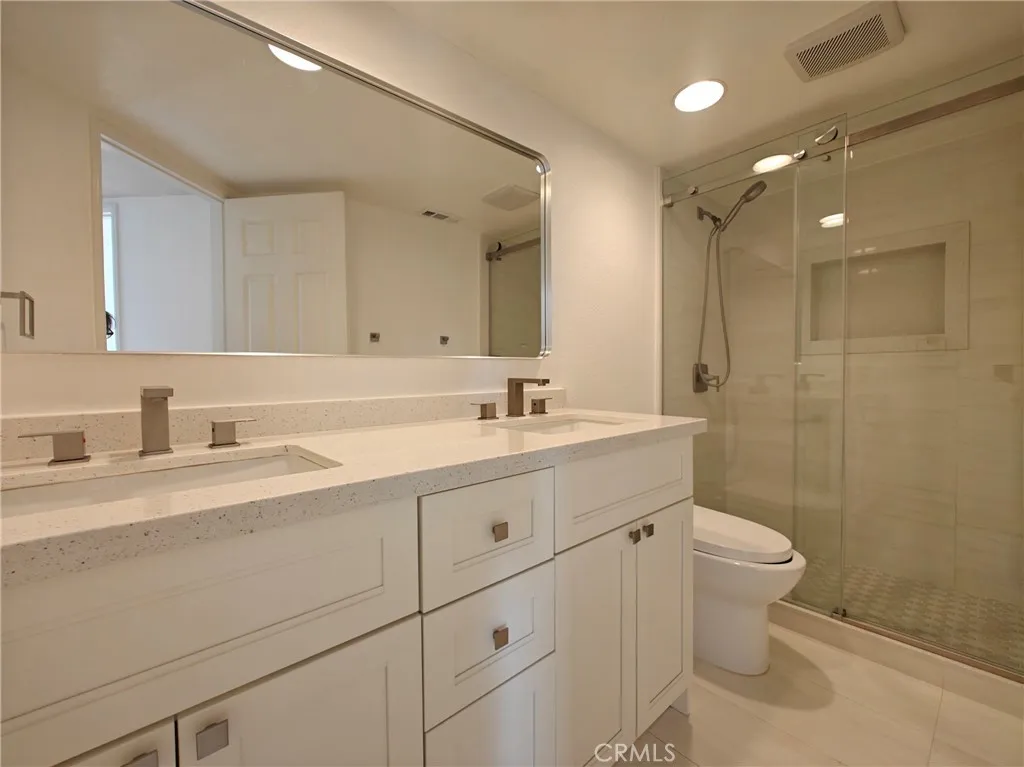 hallway bathroom with dual sinks