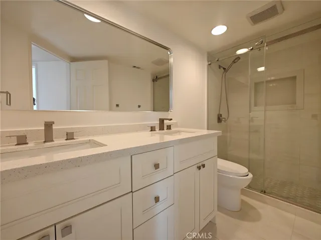 hallway bathroom with dual sinks