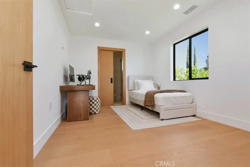 Well-appointed bedroom featuring natural daylight, warm finishes, and comfortable layout. Well-appointed bedroom featuring natural daylight, warm finishes, and comfortable layout.