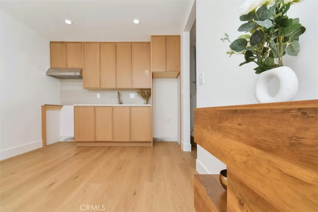 Bright and modern open-concept one bedroom ADU featuring a full kitchen with custom wood cabinetry, sleek flooring, and a spacious living area. Bright and modern open-concept one bedroom ADU featuring a full kitchen with custom wood cabinetry, sleek flooring, and a spacious living area.