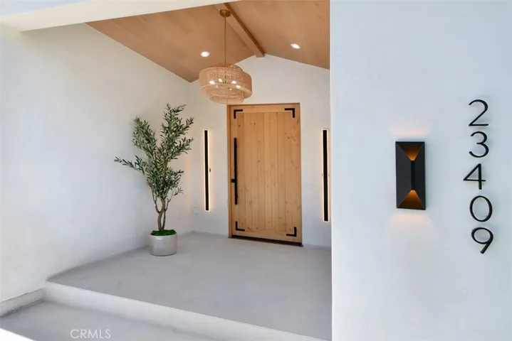 Front entrance porch featuring the stylish doorway, address numbers, and surrounding exterior detail.