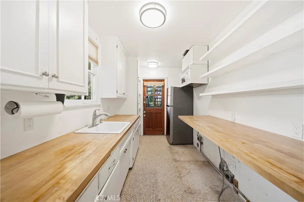 Beach style kitchen with room for under counter washer and dryer. Beach style kitchen with room for under counter washer and dryer.