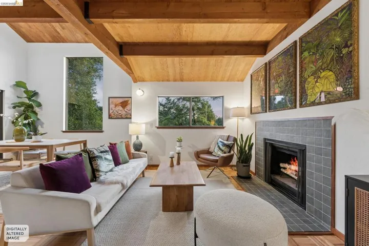 Vaulted ceilings with exposed wood beams, wood-plank ceiling treatment, and a fireplace featuring square tile surround