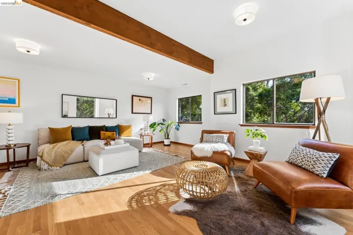 Exposed wood-finish ceiling beam, wood-finish flooring, and multiple dual-pane windows