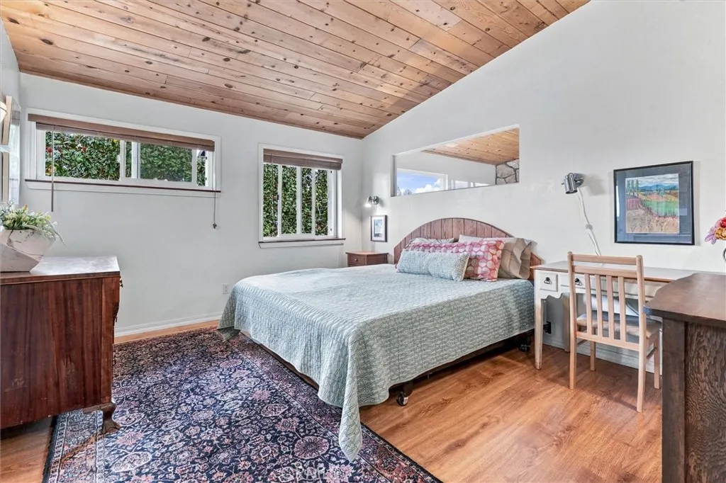 The primary bedroom also has wood vaulted ceilings and tons of light. This bedroom is located on the second floor which affords privacy while your blinds are open so you can enjoy the gorgeous views. The flooring adds such an earthy warmth. The primary bedroom also has wood vaulted ceilings and tons of light. This bedroom is located on the second floor which affords privacy while your blinds are open so you can enjoy the gorgeous views. The flooring adds such an earthy warmth.