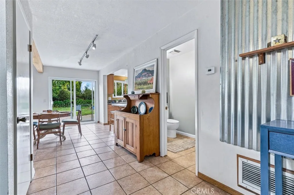 A view from the front entry area through the dining area, kitchen and out into the rear yard. A view from the front entry area through the dining area, kitchen and out into the rear yard.
