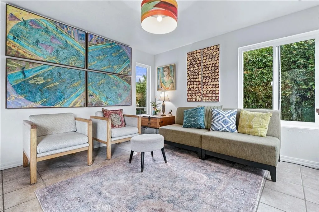 This den/dining room space can accommodate a table that seats 12 people. The tile floor is perfect for a dining space that also opens to the outdoors. This den/dining room space can accommodate a table that seats 12 people. The tile floor is perfect for a dining space that also opens to the outdoors.