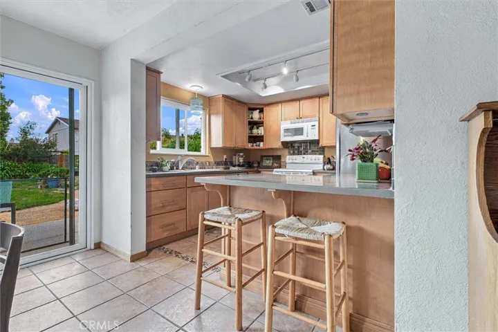 This remodeled kitchen has great storage and lots of counter space with a bar that doubles as a place for casual meals or snacking.