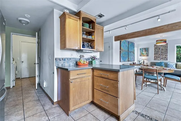 This view shows the laundry room which leads to the two car garage which makes unloading groceries convenient