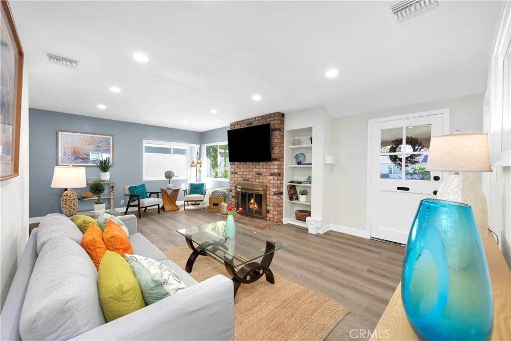 The brick fireplace and built in cabinet adds architectural detail to this lovely living room.