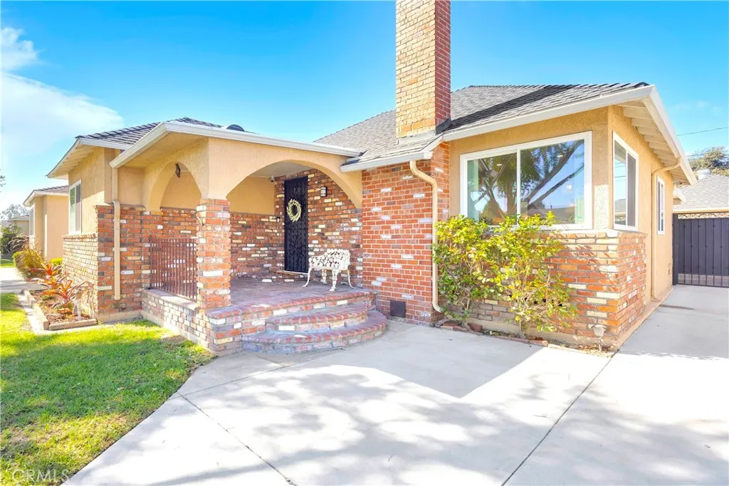 Gorgeous Brick Facade with towering chimney and upgraded windows create great curb appeal!