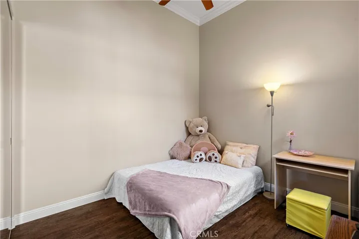 Secondary Upstairs bedroom has ceiling fan.