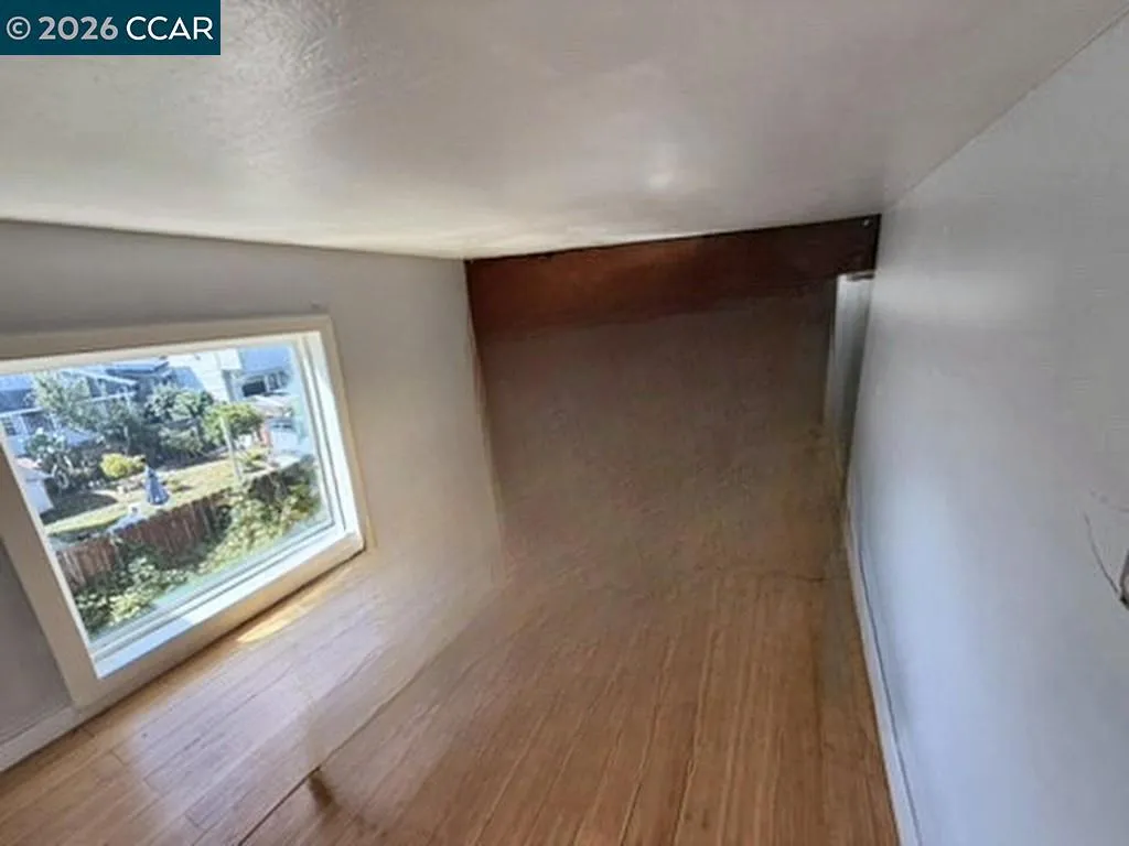 Upper level: room with rear-facing window. Digitally altered: personal property and debris removed. Unaltered photo available.