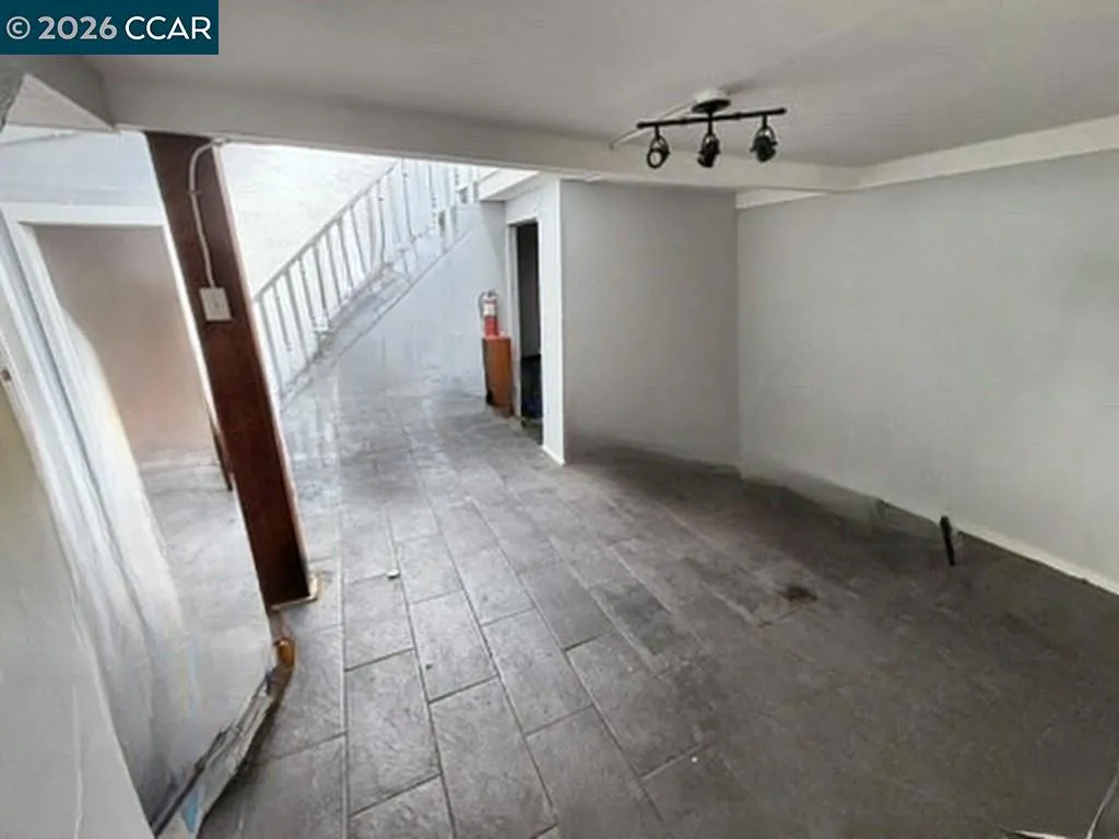 Lower level: tile floor area. Digitally altered: personal property and debris removed. Unaltered photo available.