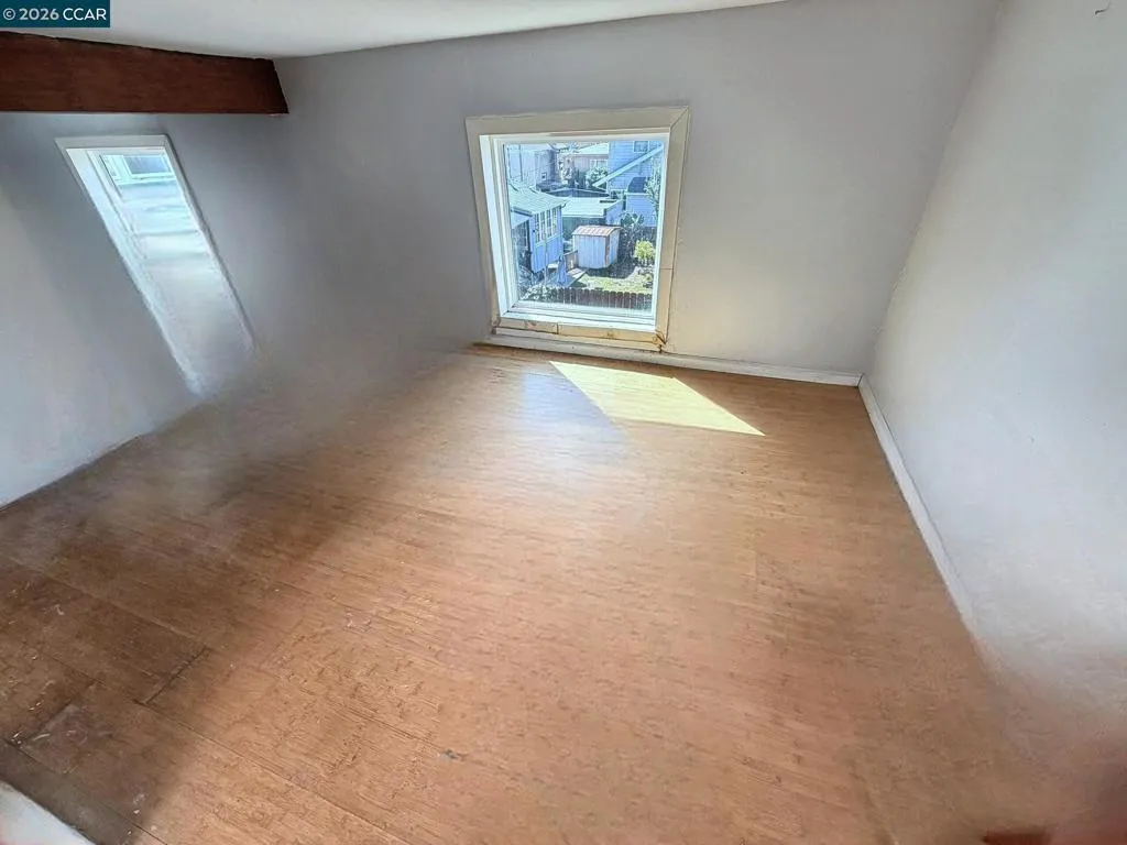 Upper level: room with rear-facing window. Digitally altered: personal property and debris removed. Unaltered photo available.