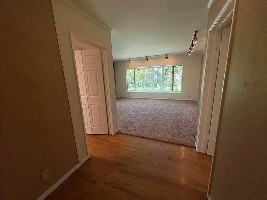 View from entrance towards living room. Reading room to left, hallway to right. View from entrance towards living room. Reading room to left, hallway to right.