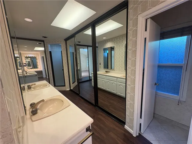 Storage behind mirrors, Toilet to right, shower to the left