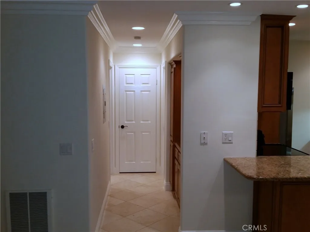 View of the hallway. Crown moldings throughout.