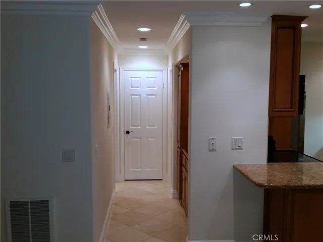 View of the hallway. Crown moldings throughout.