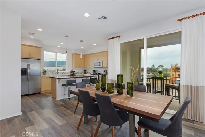 The dining room is a generous space that links with the deck for indoor/outdoor living and adjoins the kitchen with additional seating at the island overhang.