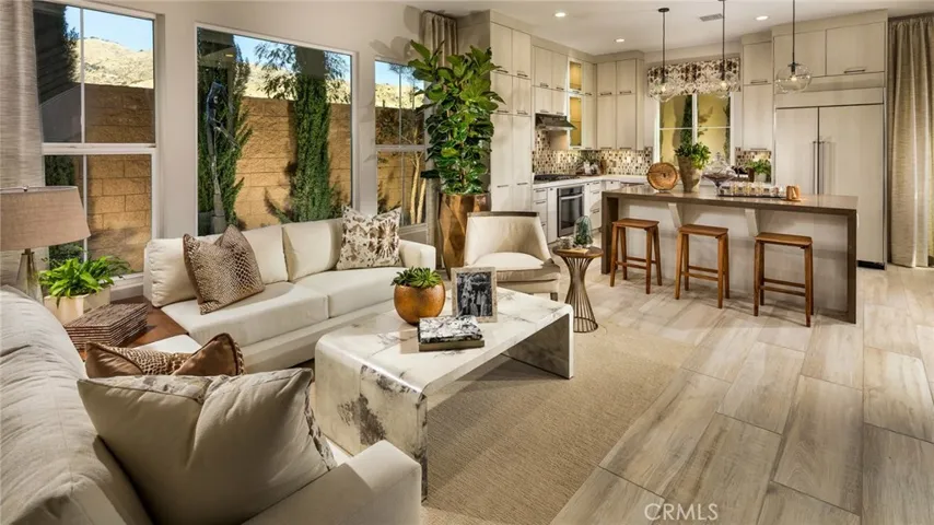 Family Room to Kitchen. Photos of model home not actual home for sale. Home is still under construction.