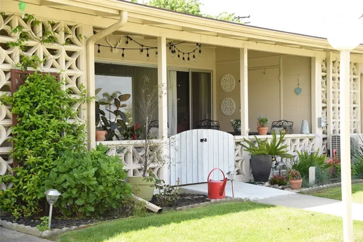 Gated walk-way onto patio showing enclosed storage space on right side of patio.