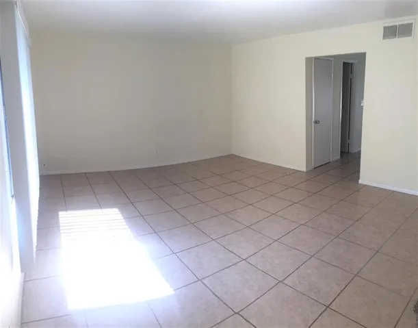 Spacious living room with tile flooring