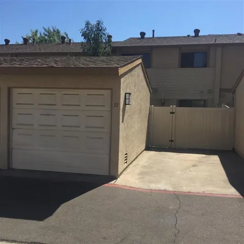 Garage with parking spot right next to it. Fence that opens to back patio area.