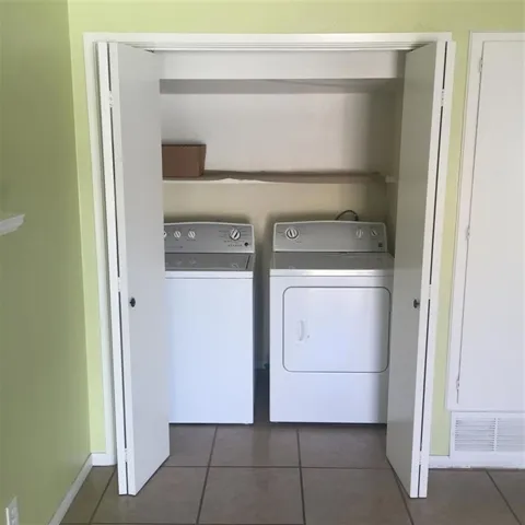 Closet with full sized washer and dryer