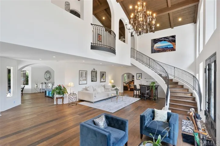 View of the grand foyer, perfect for entertaining, with sweeping staircase to the master suite and Long Gallery upstairs.