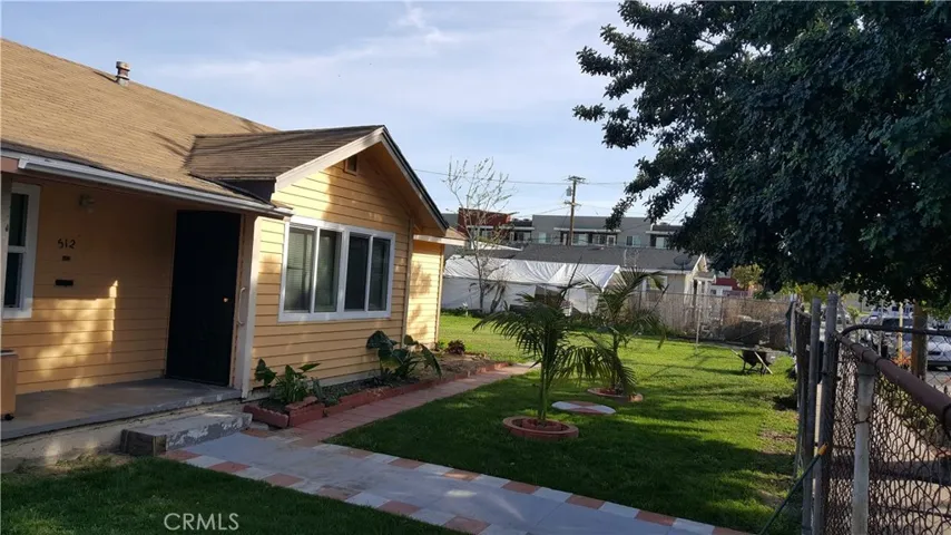 Corner house with a lot of parking, 2 bedroom 1 bath, livingroom, den and a 2 car garage with a huge lot.