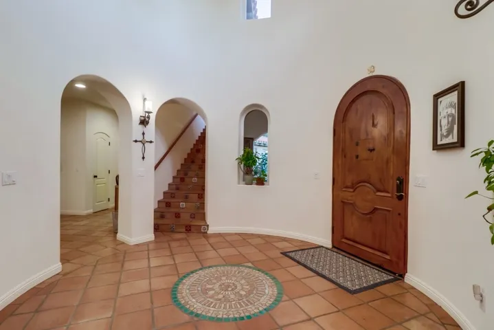Visitors are greeted by a beautiful circular entry that towers to the second floor and is adorned with skylights that provide the most lovely light