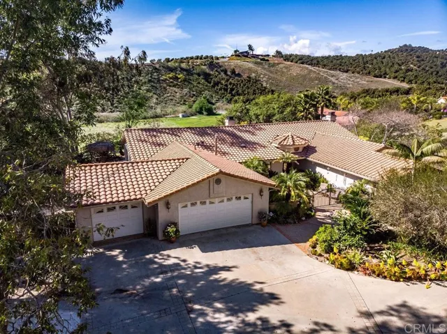 Down a tree lined driveway, welcome to 835 Grove View Road through the beautifully landscaped courtyard entry.
