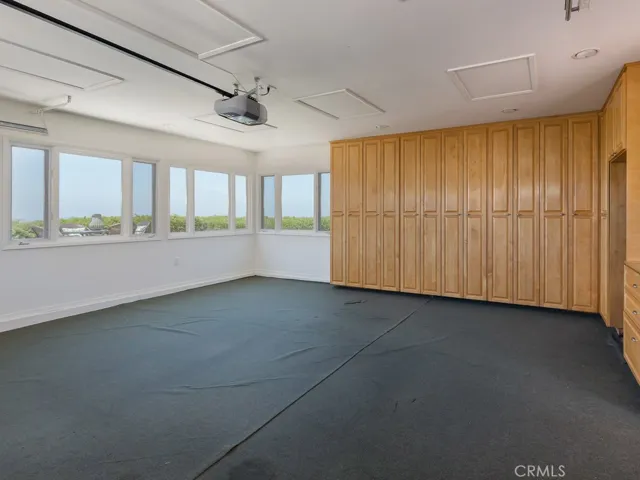 Detached garage has custom cabinets for storage, newer window, amazing ocean views. Great place to make a home gym or office space.