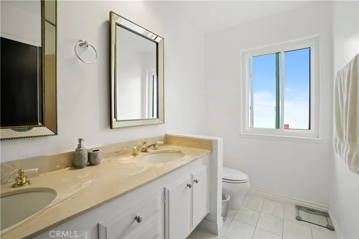 Primary suite bathroom with dual vanity and shower