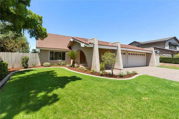 Beautifully landscaped front yard with 3-car garage