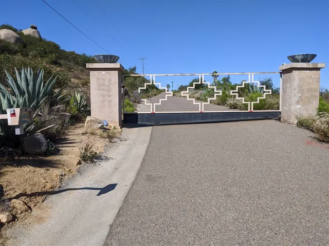 Entry gate at NE corner of lot.  Property is beyond the gate on left side of the road.
