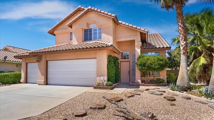 Front of house with 3 car garage and low maintenance landscaping