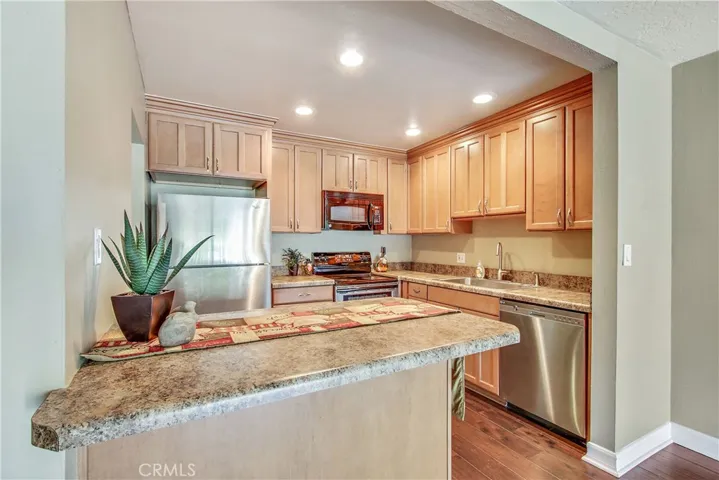 Light, bright remodeled kitchen featuring stainless appliances.