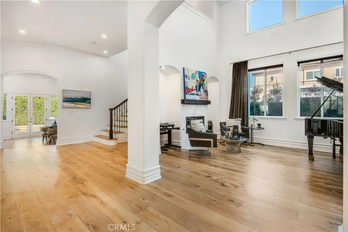 Upon entering, to the right, enjoy the formal living room with fireplace and sky high ceilings.