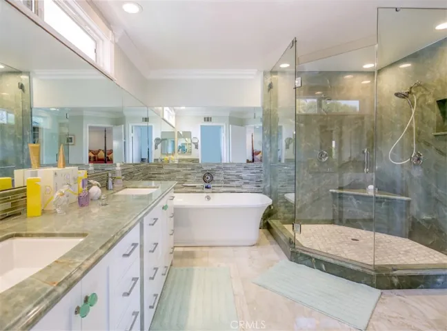 Gorgeous and completely upgraded! An oversized, walk-in shower and free-standing tub make this master bath an oasis, located just off the master bedroom!