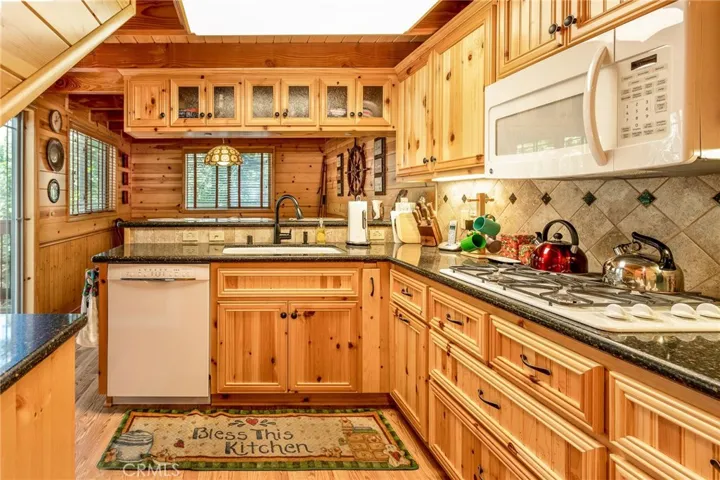 Kitchen with new appliances and quartz counters.